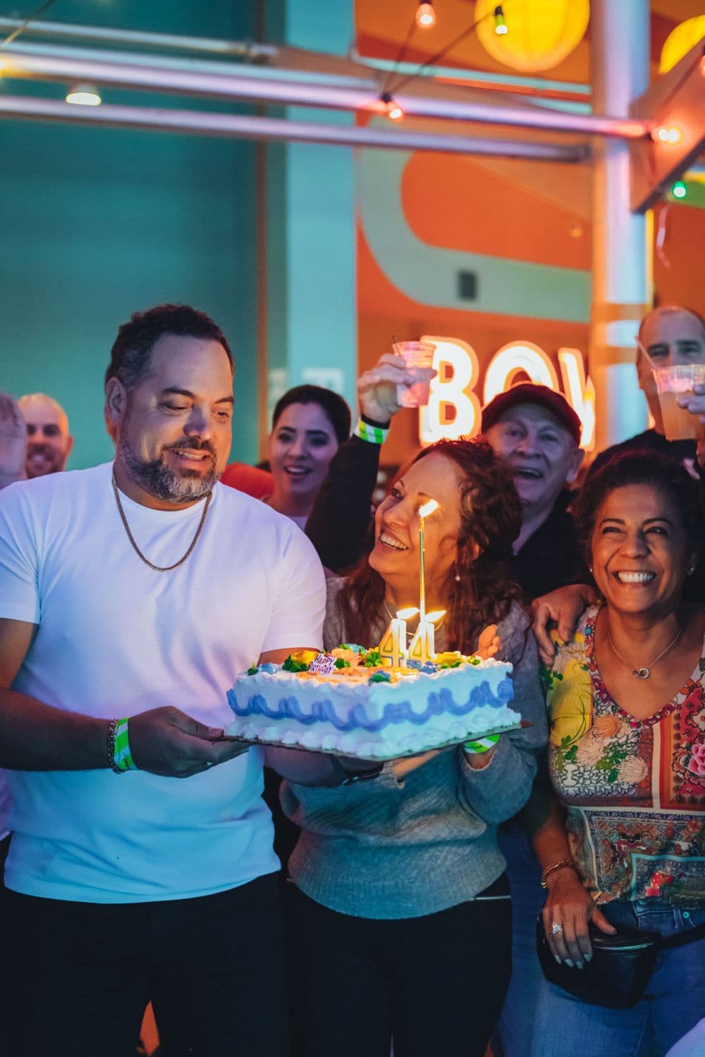 Friends gathered around a birthday cake